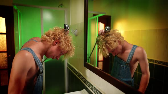 Side View Young LGBT Man Washing Hair in Slow Motion in Front of Mirror in Bathroom