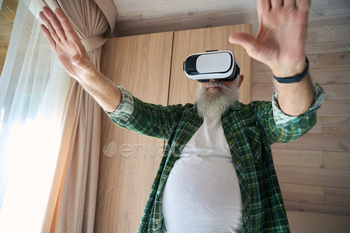 Elderly man wearing virtual reality glasses
