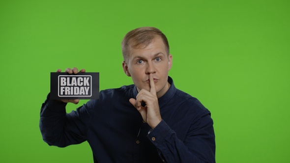 Man Showing Black Friday Inscription, Putting Finger on Lips Making Silence Gesture. Chroma Key