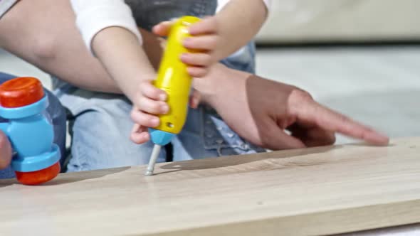 Family Playing with Toy Tool Set