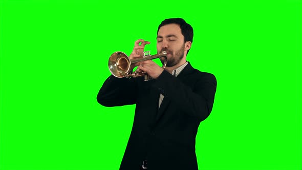 Young Musician Playing Trumpet on a Green Screen