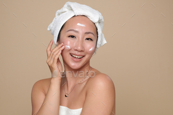 Woman Applying Rich Face Cream