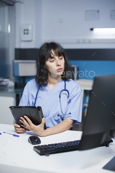 Nurse reviewing files with technology