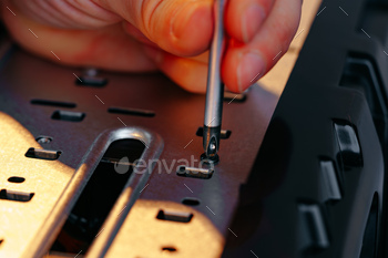 Male hands repairing computer hardware close up