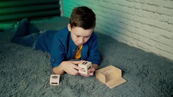 boy play with wooden block calendar.
