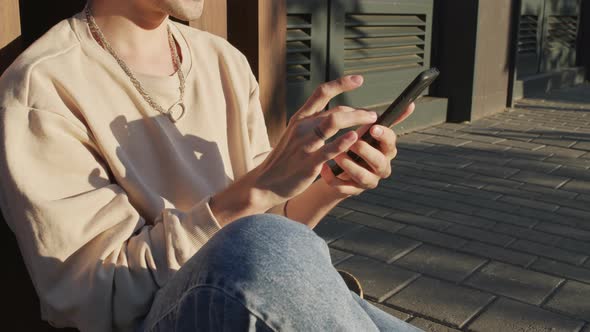 Cropped Guy Using Smartphone Outdoors