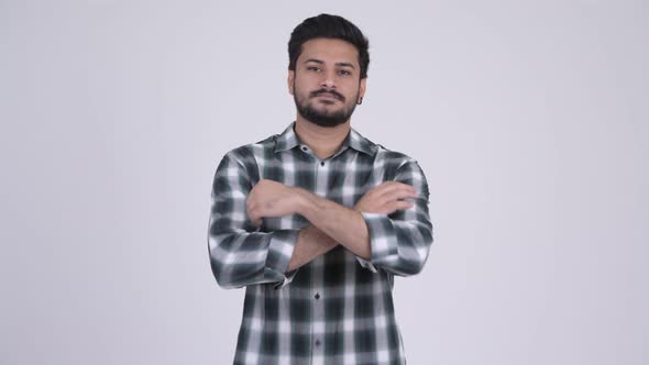 Portrait of Young Happy Bearded Indian Man with Arms Crossed