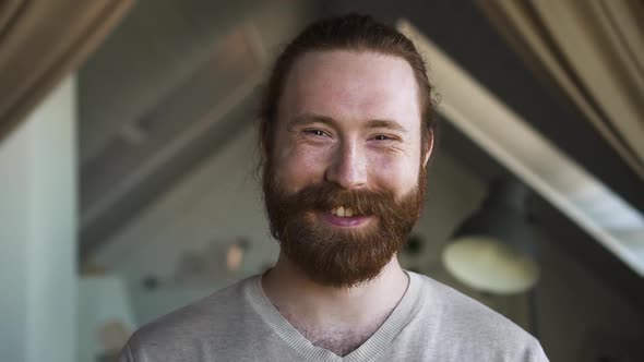 Young Redhaired Man is Smiling and Posing in Front of Camera at Home Room Spbd