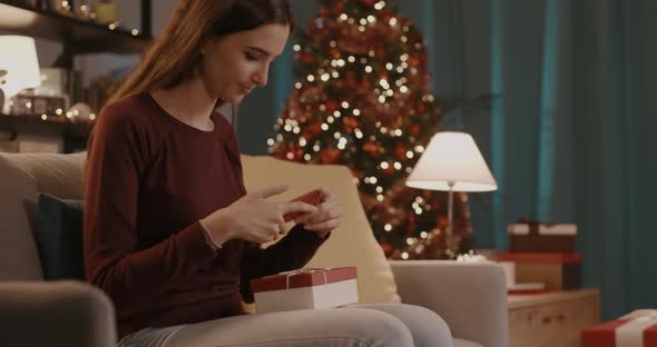 Happy woman taking a selfie with her Christmas gift