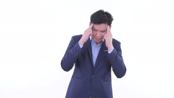 Stressed Young Asian Businessman Having Headache