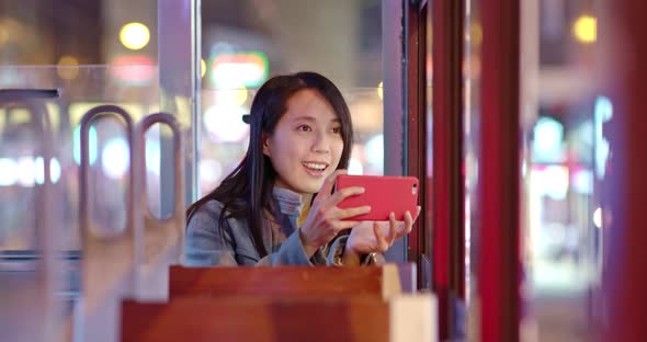 Woman take photo on tram