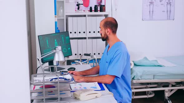 Man Practitioner Working in Medical Office with Digital Body Scan