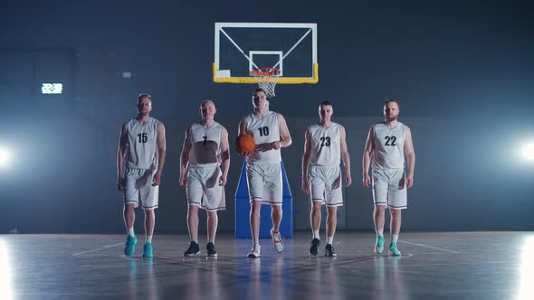 Slow Motion Group of Basketball Players Goes Through the Playground the International Basketball