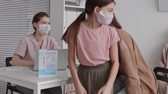 Young Nurse Registering Patients