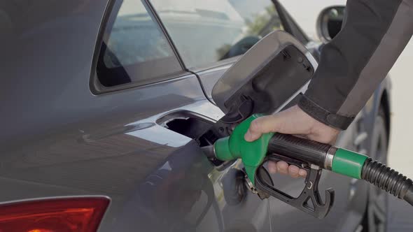 Filling Car With Gas fuel at station pump
