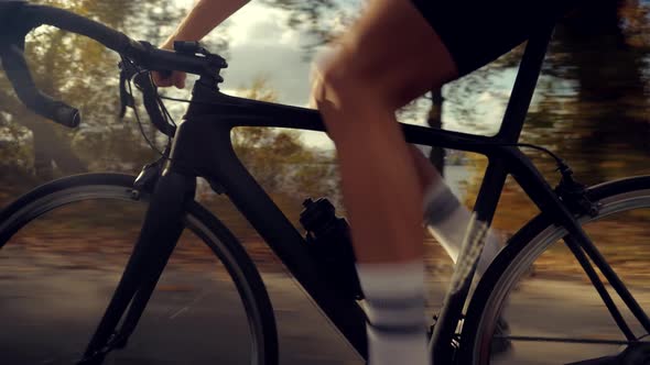 Cyclist Training Leisure Twists Pedals On Triathlon Bicycle. Gear System  And Bike Wheel.
