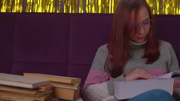 Tired Female Student Reading Among Books