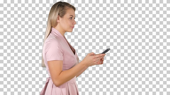 Pretty woman in pink dress texting on smart phone, Alpha Channel