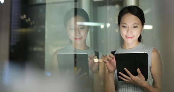 Woman using tablet computer at night