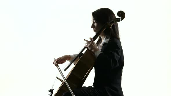 Female Hand Plays on a Cello in White Studio Music Sheets