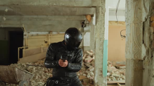 Motorcyclist with Gun Hides Behind Wall in Old Building