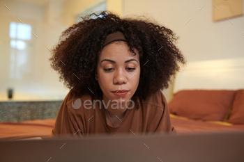 Woman Reviewing Code on Laptop Screen