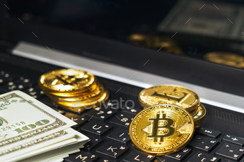 Bitcoins coin and banknotes on keyboard compute