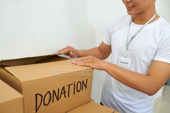 Volunteer Opening Box with Donations