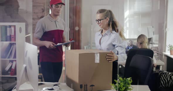 Woman Sends a Parcel in Box By Courier