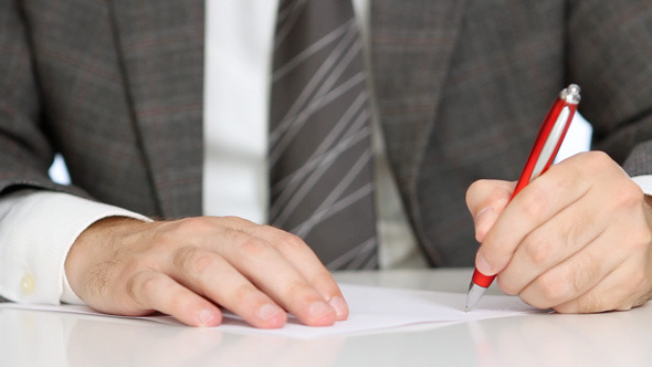 Businessman Writing Application Form