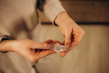 Woman opening a case containing a contact lens. Vision Correction and Health Care. Contact Lenses.