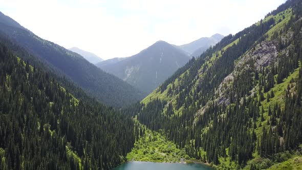 Kolsay Lake Among Green Hills and Mountains