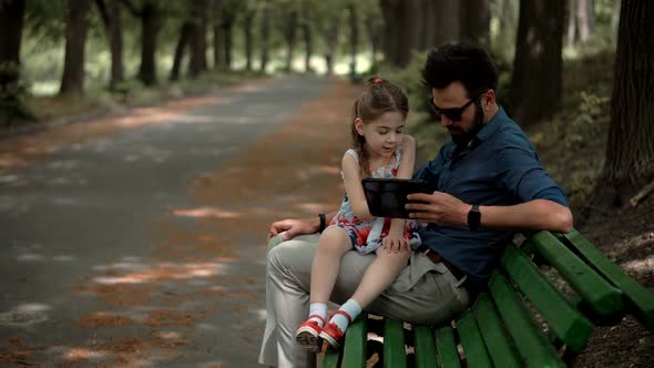 Little Cute Preschool Girl Tap Pad Screen. Daughter With Father Learning Tablet Digital Technology.