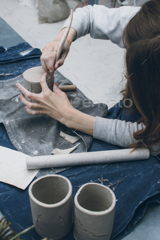 Creative woman working in pottery studio