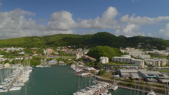 Aerial of boats moored at marina harbor on a sunny day, Le Marin