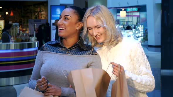 Women Look Into the Shopping Bag at the Mall