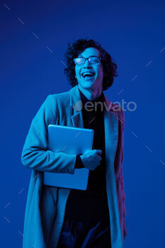man with a laptop in his hands and a jacket, smile, glasses in blue light, Blue Perennial color