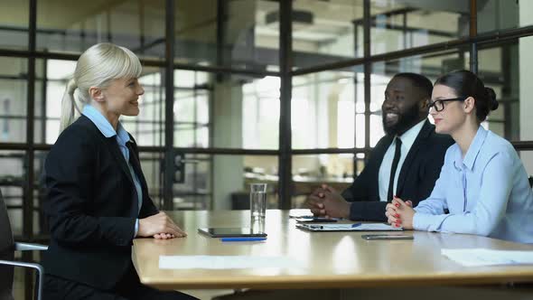 Blond Business Woman Shaking Partners Hands, Greeting in Office, Profession