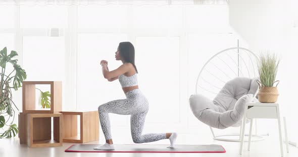 Athletic fit girl doing fitness aerobic exercises for booty in living room.