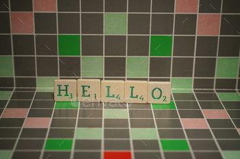 Tile with green hello text on a blocked background