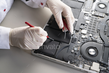 a laptop battery fix, serviceman changing the battery components