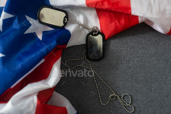 Army tokens on American national flag background.