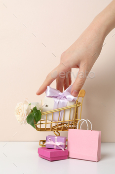 Shopping cart with flowers on a light background.