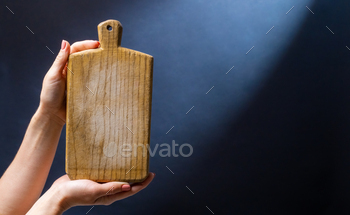 Hand holding kitchen board