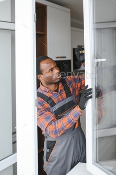 African service man installing window