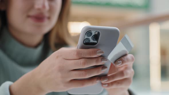 Close Up Female Hands Holding Telephone and Credit Card Unrecognizable Woman Booking Order Online