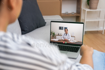Patient at home in a relaxed setting engaging with a doctor on a laptop,  telemedicine