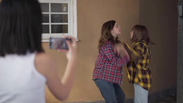 Caucasian Teenage Girl Steaming Online Fight of Angry Classmates Outdoors