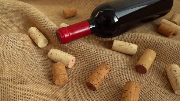 Wine in bottles and falling corks on the bag. Slow motion