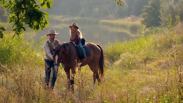 Cowboy and His Daughter on Horseback